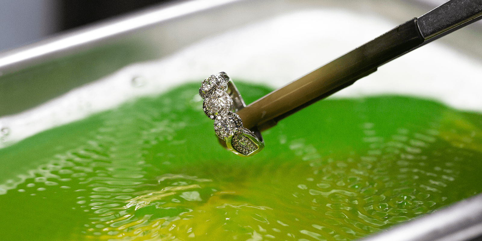 Photo of diamond ring being cleaned in ultrasonic cleaner.