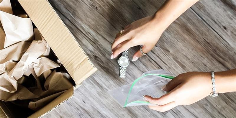 Hands Packing Watch Timepiece and Jewelry to Mail In Repairs to My Jewelry Repair