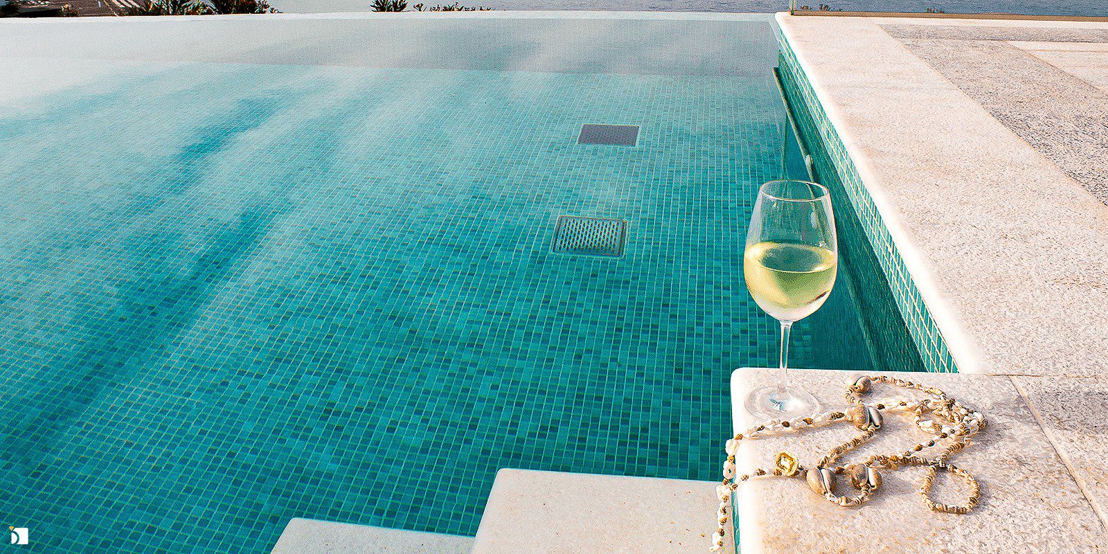 Image Showing Cleaned and Polished Necklace Next to Luxury Pool