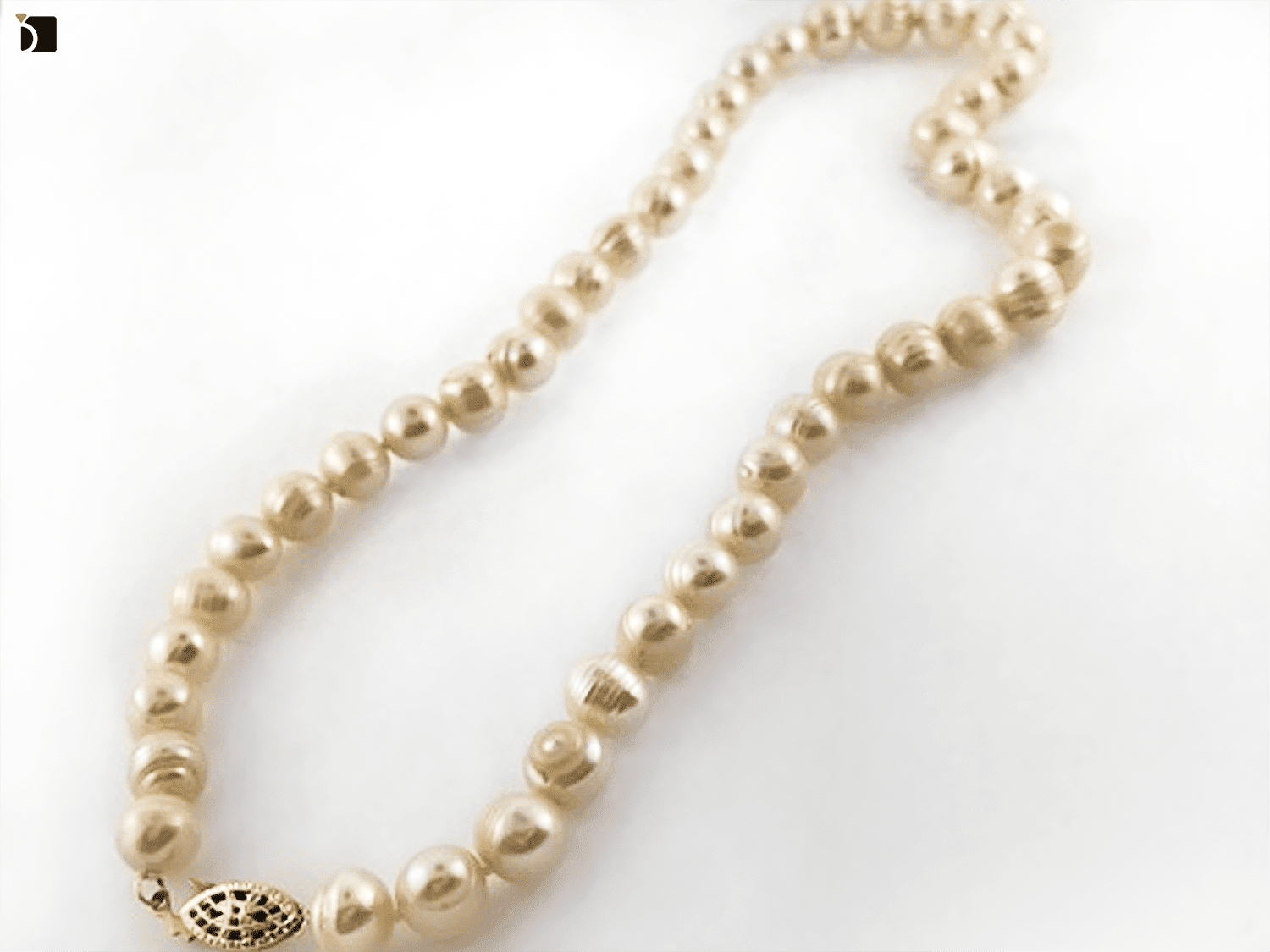 Image showcasing a string of pearls necklace after it gets a necklace repair