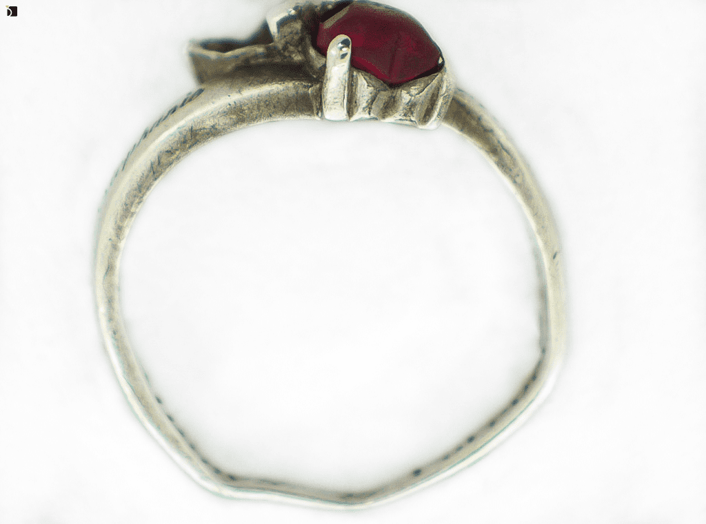 Image Showcasing Side-View of a Silver Ring Before It Gets Restored and a Gemstone Replacement