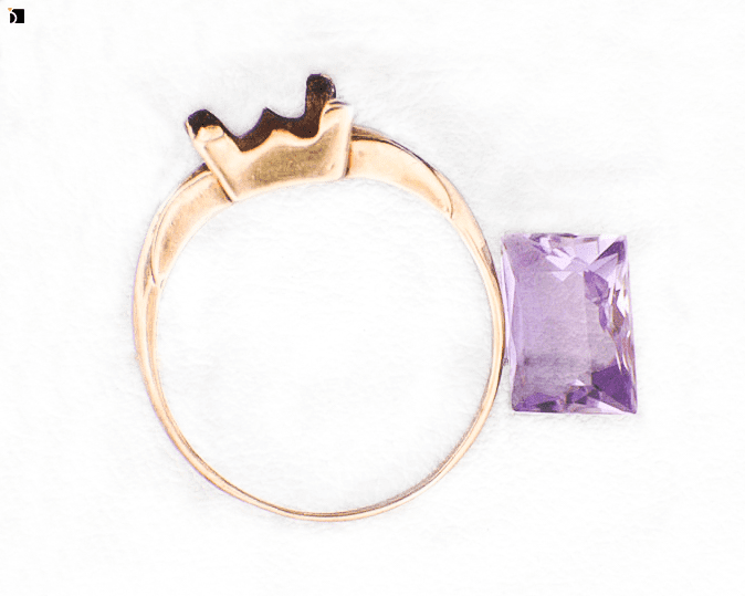 Image Showcasing Before #2 Flat View of a Gold Ring with Purple Gemstone Getting Extreme Transformation Through Premier Ring Repair Services and Gemstone Resetting by My Jewelry Repair Master Jewelers