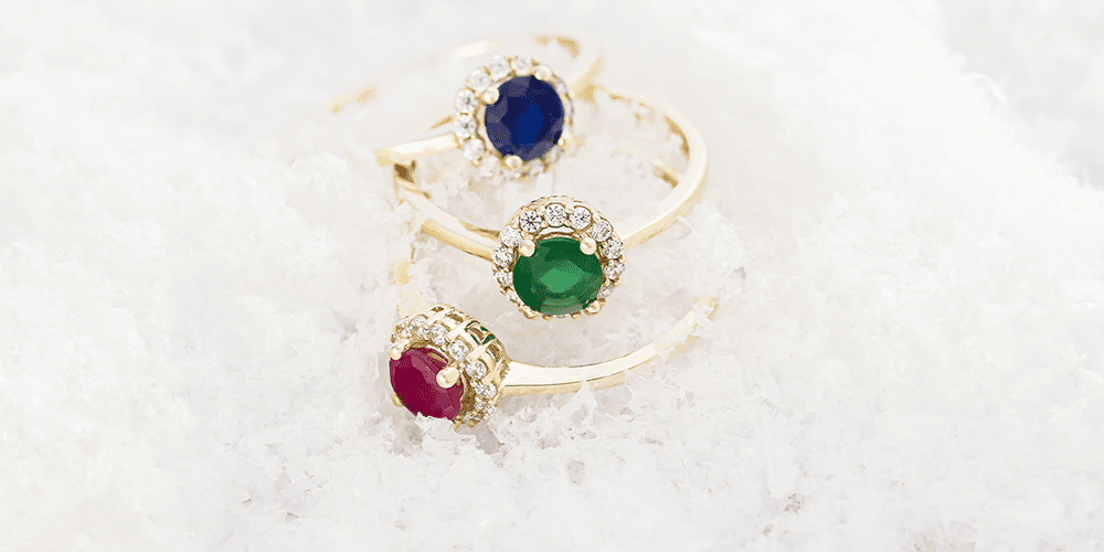 Winter Fine Jewelry Gold Gemstone Sapphire Emerald Ruby Restored Rings Displayed in Snow