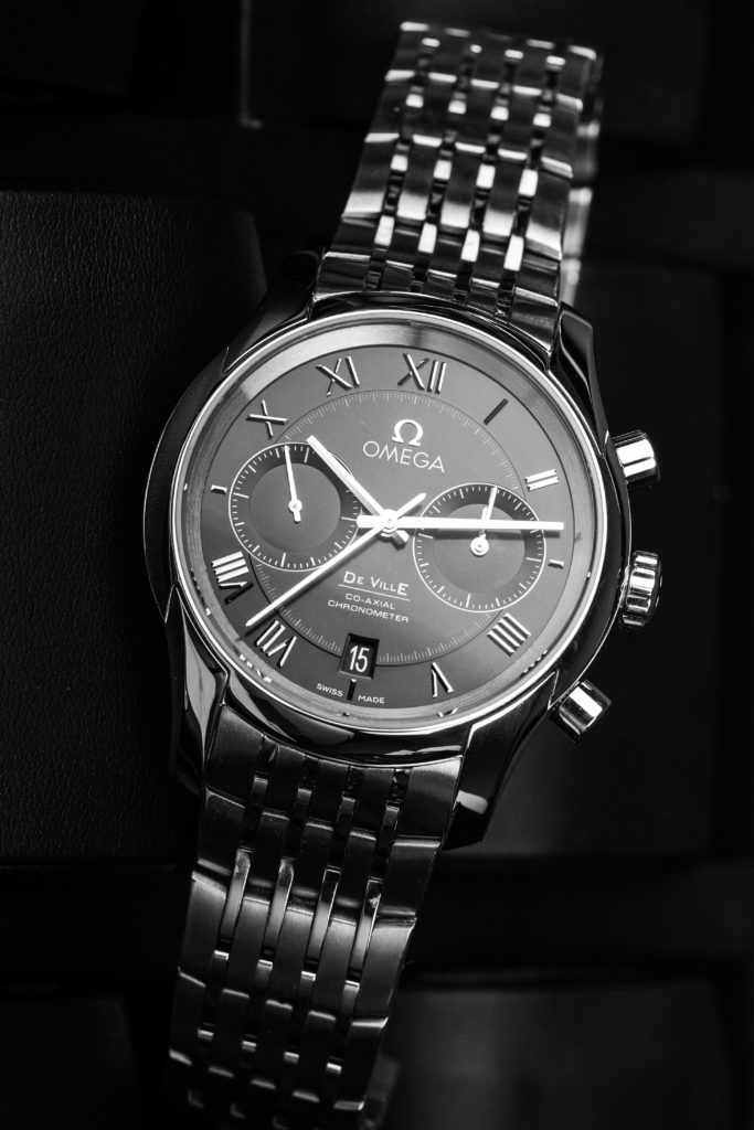 Image showcasing omega de ville watch in black & white