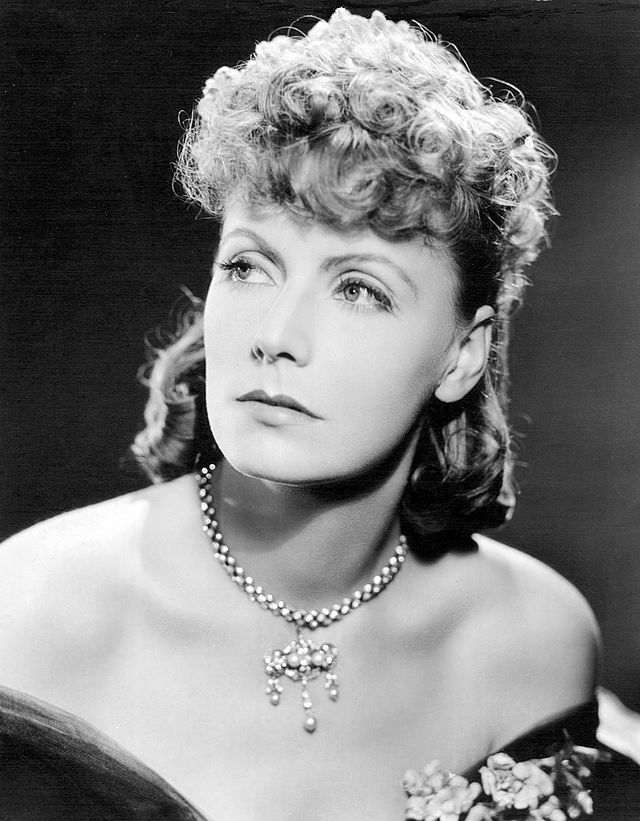 Image showcasing Greta Garbo wearing jewelry in black and white