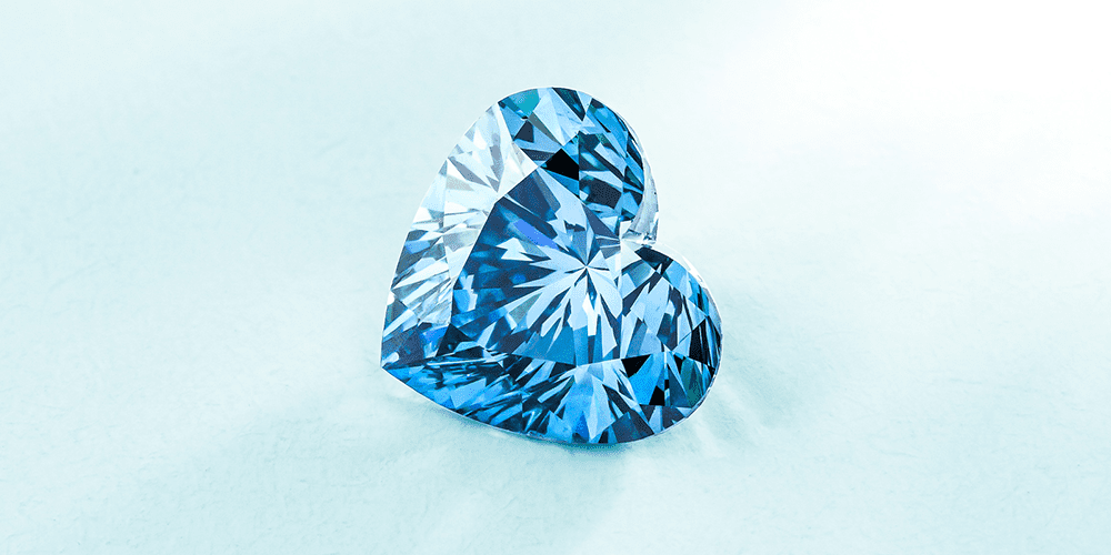 Polished Heart-Shaped Aquamarine Loose Gemstone Displayed on Baby Blue Background