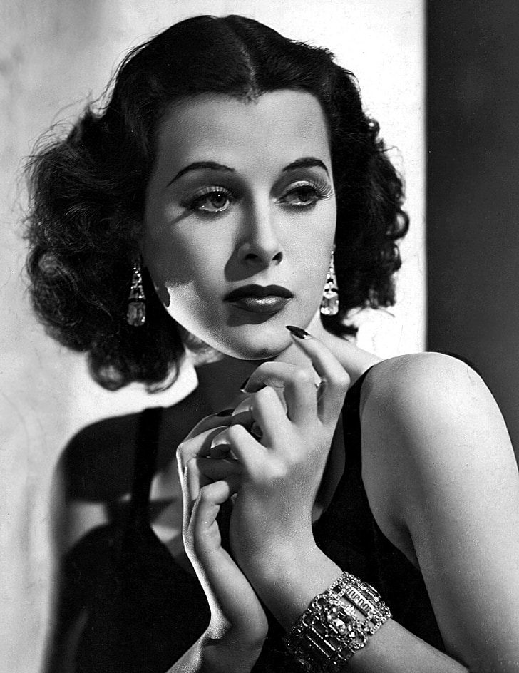 Image showcasing 1930s French model Capucine wearing jewelry in black and white