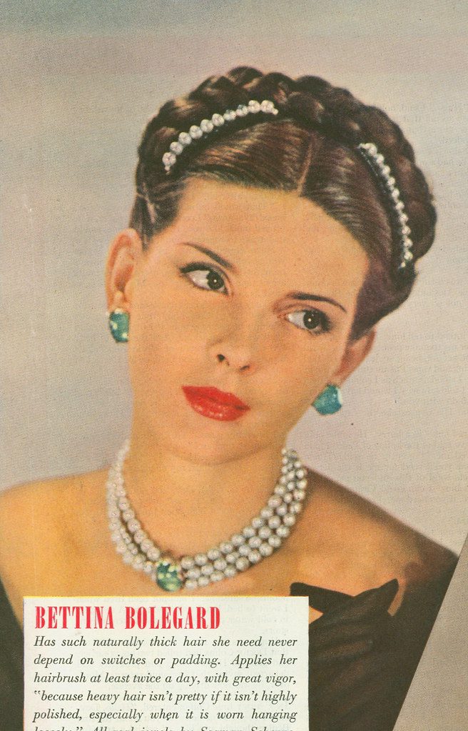 Photo showing 1940s woman in colored magazine wearing pearl and green gemstone jewelry