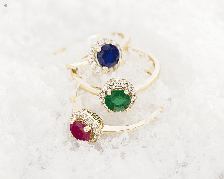 Restored Fine Jewelry Gold Engagement Rings with Sapphire Emerald Ruby Center Stones Diamond Cluster Displayed in Snow