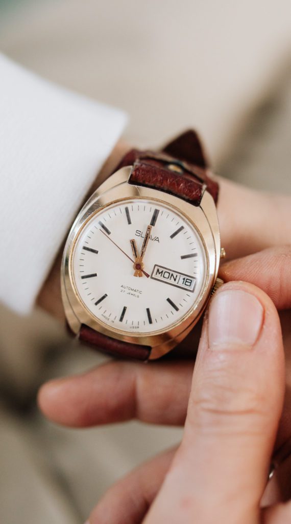 Photo showcasing watch being wound up by hand