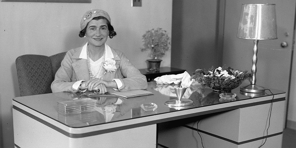 Coco Chanel Sitting at Desk Featured Image