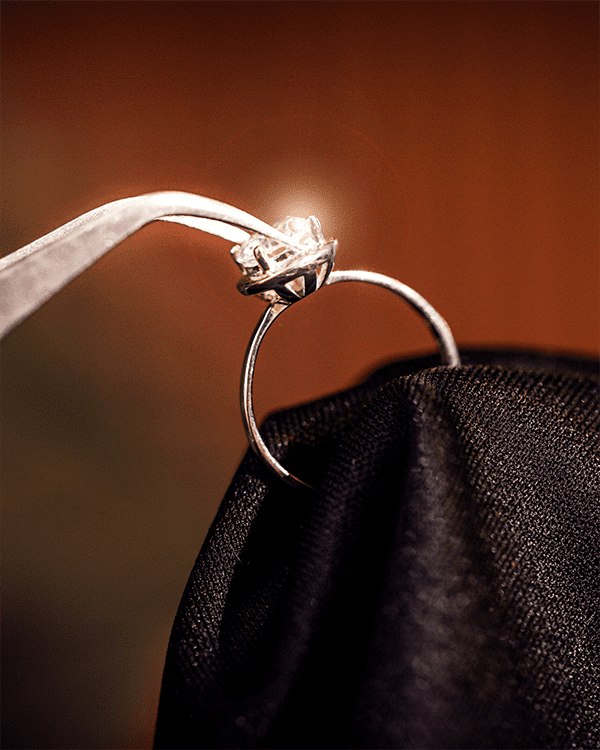 Close Up of Master Jeweler Using Tool Resetting Diamond Gemstone Ring Repair Restoration Services