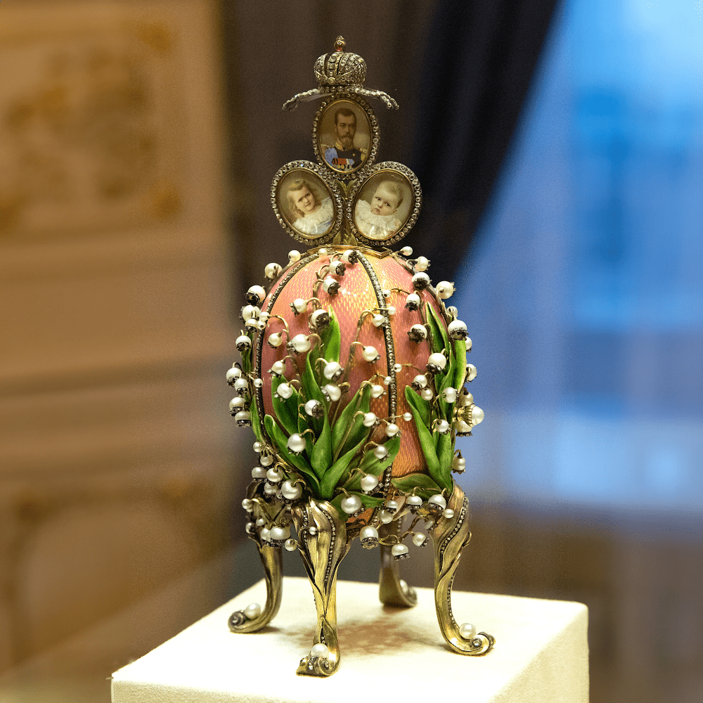 Photo of pink Fabergé egg adorned with pearls and family photo