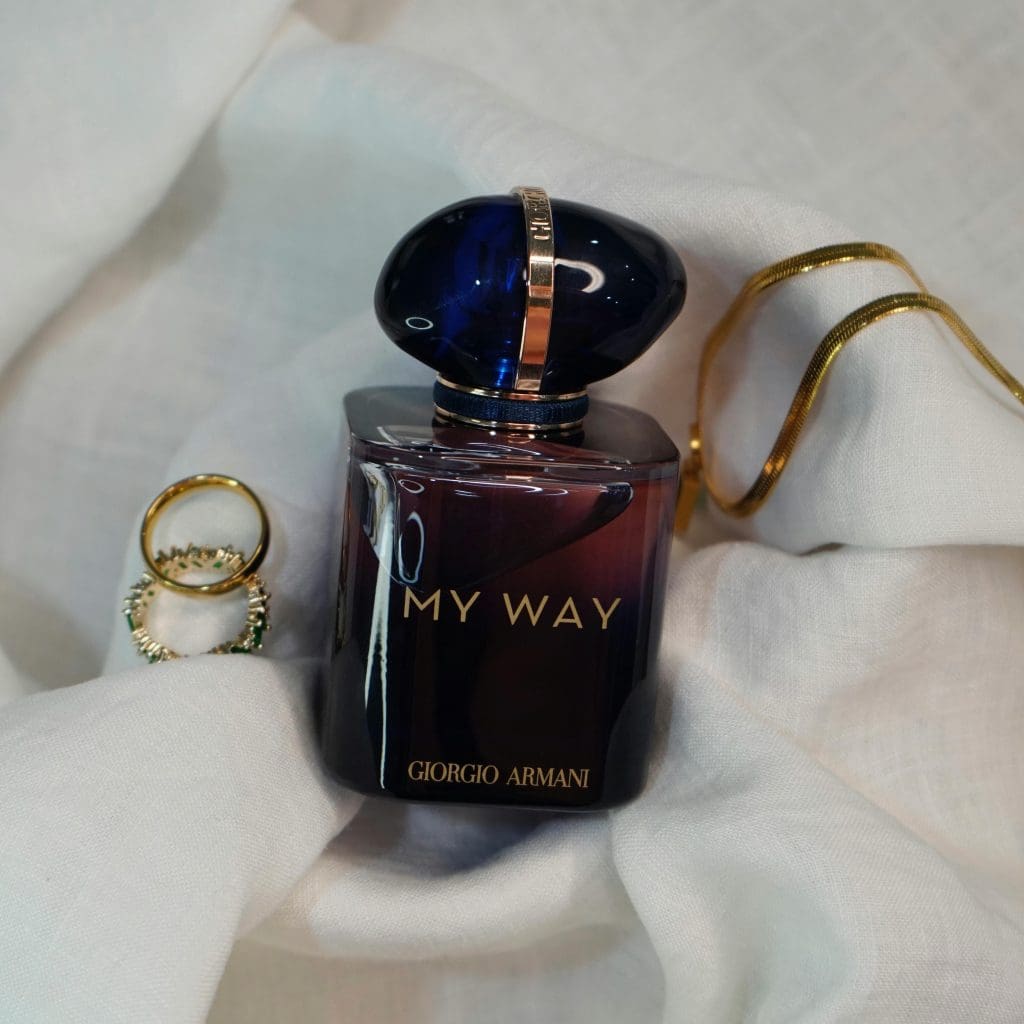 Image showing armani jewelry with armani perfume on white cloth
