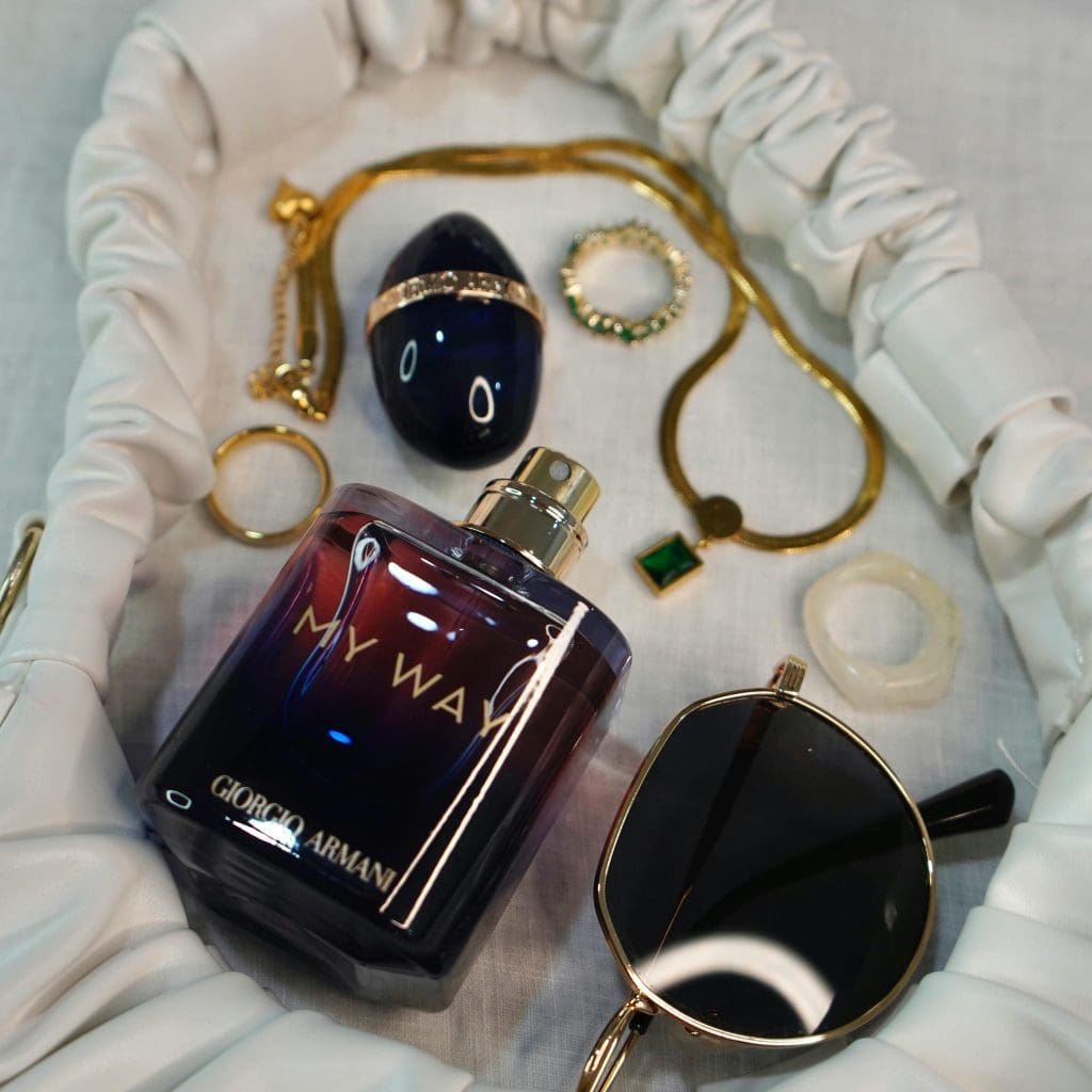 Image showing armani jewelry with armani perfume and sunglasses on white cloth
