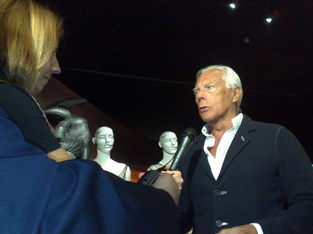Image of giorgio armani being interviewed at fashion show