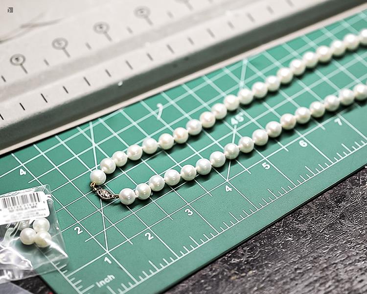 After #181 Pearl Necklace After Professional Pearl Restringing Services on Jeweler's Bench