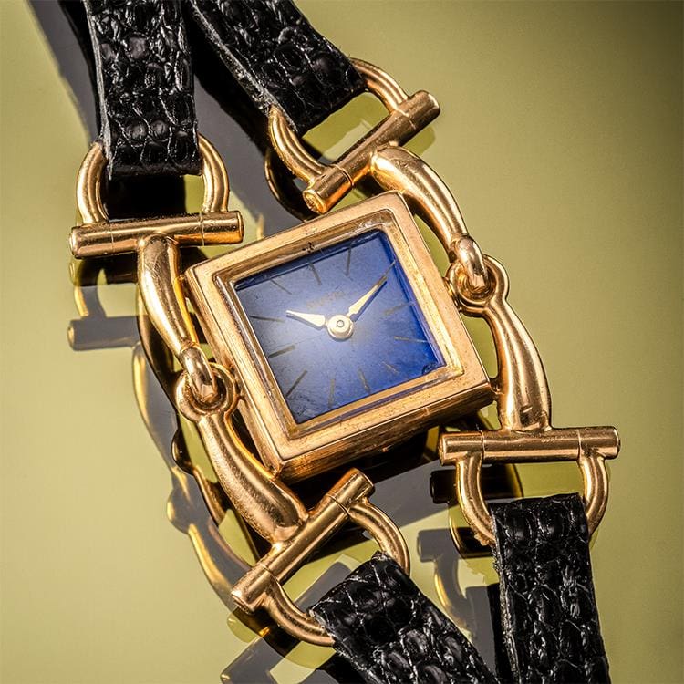 Close Up of Vintage Fashion Timepiece Gucci Watch on Green Background Watch Repair Featured Image