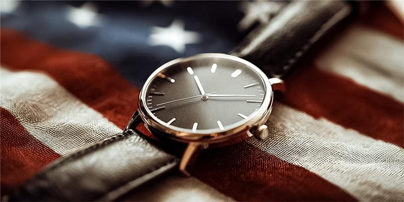 Restored Black Timepiece Displayed on USA Flag for American Watch Repair Services Nationwide