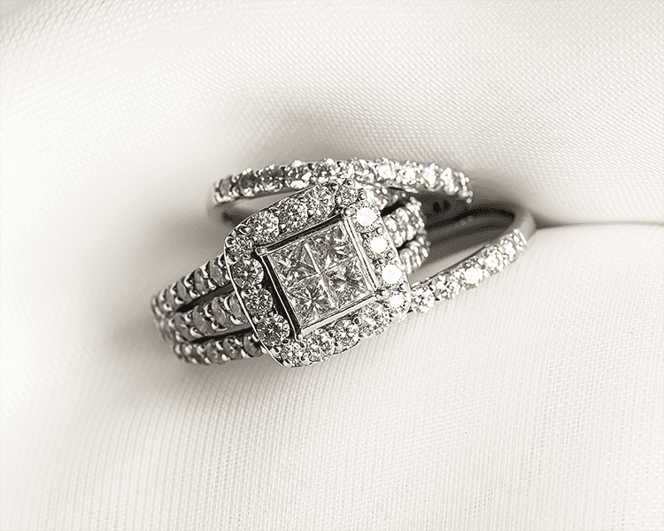 Invisible Setting Engagement Ring Displayed with Diamond Wedding Bands