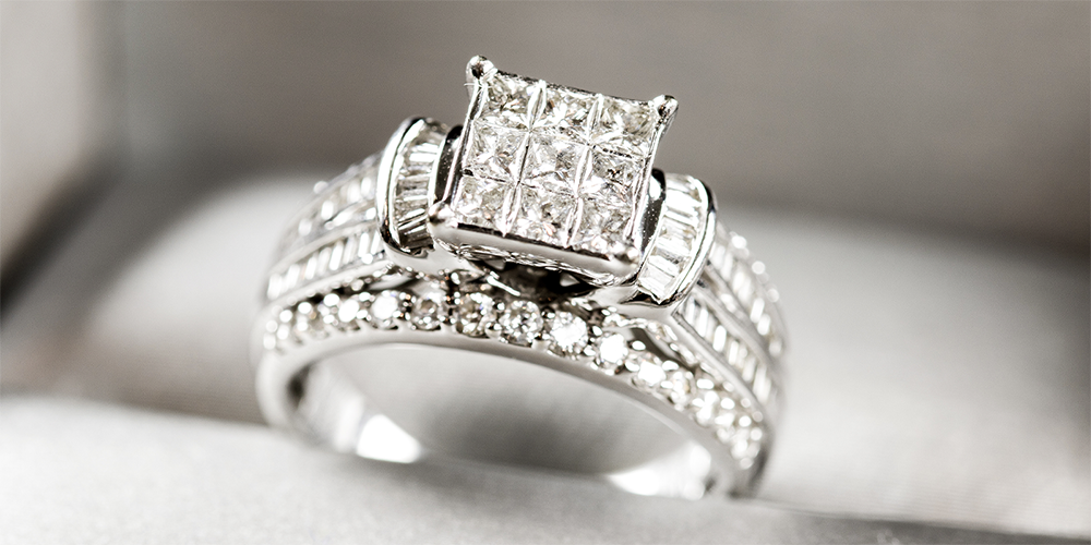 Restored Large Invisible Set Diamond Ring Displayed in Ring Box Featured Image