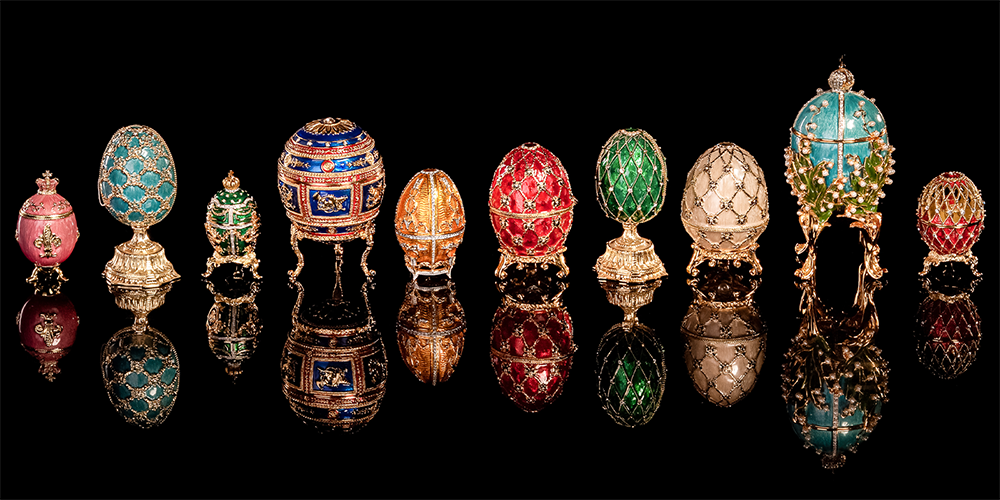The Brief History of Fabergé Eggs Pieces on Display Reflected on Black Background