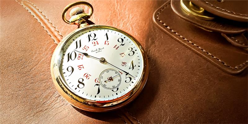 Restored Pocket Watch by My Jewelry Repair Displayed on Leather Bag