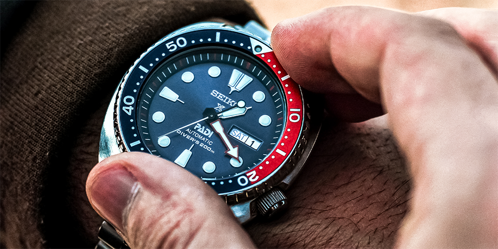 Close Up of Hand Turning Bezel of Seiko Automatic Watch on Wrist