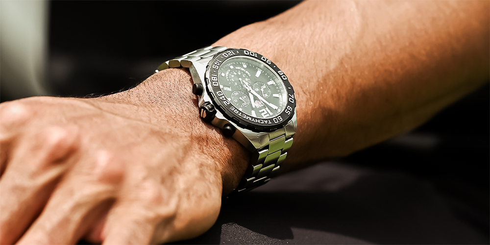 Close Up of Man's Wrist Wearing Serviced Tag Heuer Chronograph Watch Timepiece