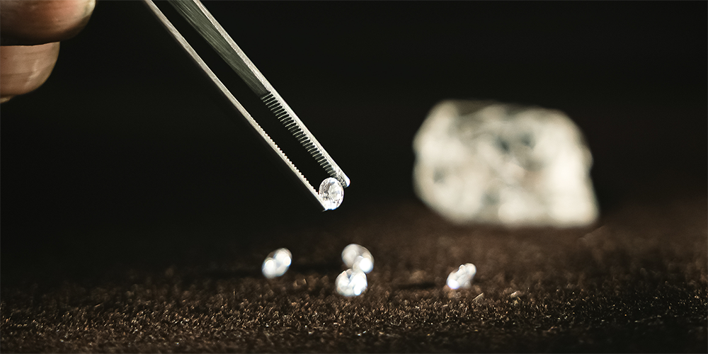 Jeweler Using Tweezer Tool to Hold Loose Diamond Gemstone