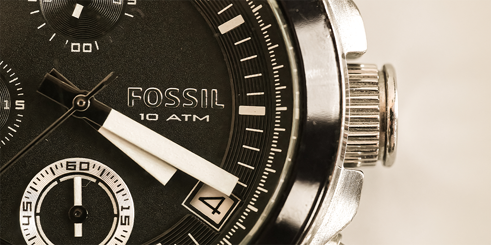 Macro Close Up of Black Silver Fossil Watch on White Background