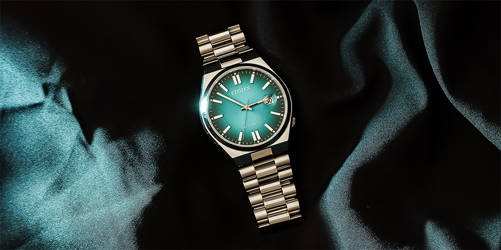 Serviced Blue Automatic Citizen Timepiece Displayed on Blue Cloth for Professional Watch Services