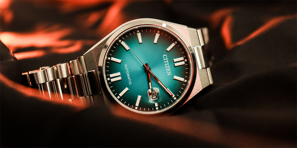 Serviced Blue Automatic Citizen Timepiece Displayed on Red Cloth for Professional Watch Services