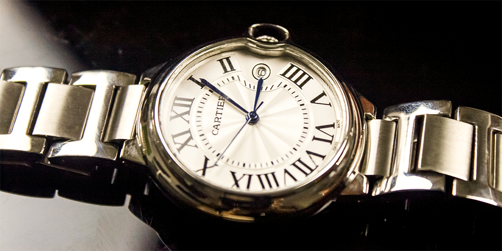 Serviced Cartier Watch Displayed Flat on Black Reflective Case