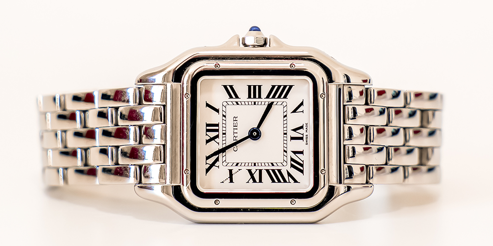 Servied Cartier Watch Timepiece Displayed Sideways on White Background