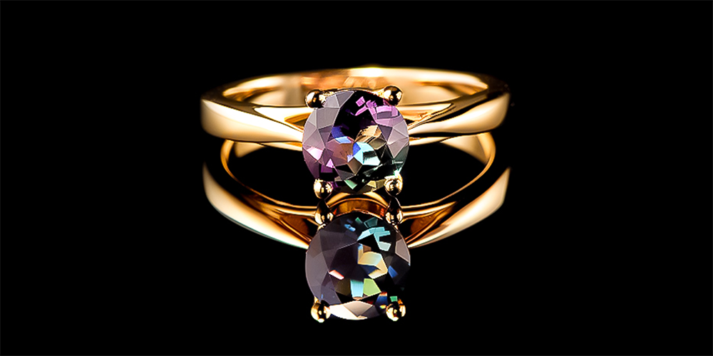 Alexandrite Gemstone Replacement Services Ring Displayed on Black Reflective Background