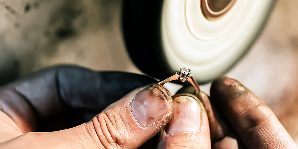 Jeweler Professionally Polishing Solitaire Diamond Engagement Ring